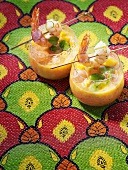 Cold melon and mango soup with prawns on cocktail sticks