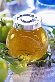 Green tomato jelly in screw-top jar