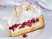 Piece of redcurrant cheesecake with almond meringue