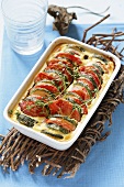 Courgette and tomato gratin in baking dish