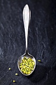 Chopped pistachios on a spoon