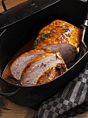 Stuffed breast of veal in roasting tin