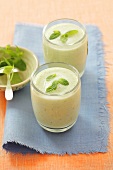 Cold cucumber and yoghurt soup with peppermint in drinking glasses