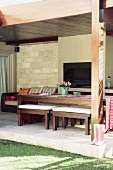 Covered terrace with dining table and built-in barbecue