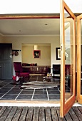 View through open terrace door into living room furnished in African style