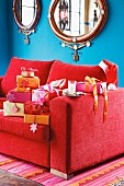 Christmas gifts on a red sofa