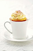 Mango cupcake in a cup and saucer