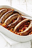 Sausages with salsa in baking dish