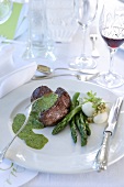 Beef fillet with herb sauce, asparagus and potatoes