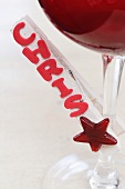 Clothes peg with name attached to wine glass (place card)