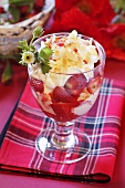 Ice cream sundae with strawberries, cream and flaked almonds