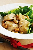 Fish with lettuce, cashew nuts and cheese dressing