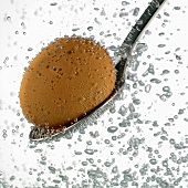 Egg on spoon in water