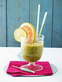 Kiwi fruit and ginger smoothie with slices of citrus fruit