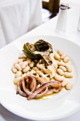 Fish with artichoke, onion and beans