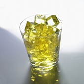 Yellow jelly cubes in a glass