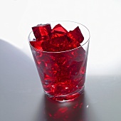 Red jelly cubes in a glass