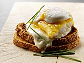 Poached egg and haddock on toasted bread