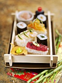 Assorted sushi on a wooden tray