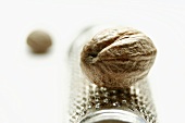 Nutmeg lying on a nutmeg grater