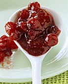 Strawberry and redcurrant jam on a spoon