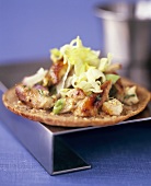 Pieces of fried fish with salad on a flatbread