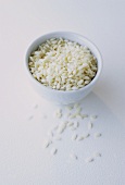 White rice in and in front of a small white bowl