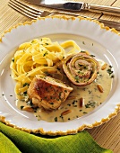 Pork roulade, a slice cut off, with cream sauce & ribbon pasta
