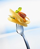 Penne with vegetables on a fork
