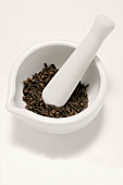 Cloves in a mortar with pestle