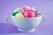 Pastel-coloured flying saucers in a cup