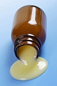 Royal jelly running out of a small bottle