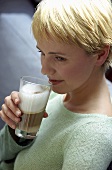 Woman drinking a latte macchiato