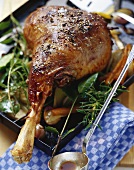 Braised leg of lamb with rosemary on baking tray