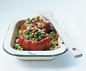 Baked tomatoes stuffed with peas and pine nuts