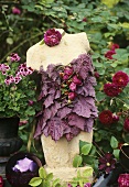 Garden decoration: torso with corsage of flowers & leaves