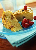 Two pieces of raisin rice cake, served with raspberries