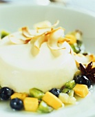 Pannacotta with coconut shavings and fruit salad