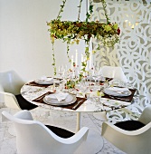 Table with four place-settings, glasses, candles