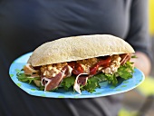 Ham, cottage cheese and rocket in ciabatta sandwich