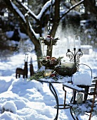 Table decorated for Christmas in snowy garden