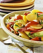 Potato salad with tomatoes, avocado and salami