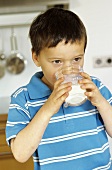 Small boy drinking milk from a glass