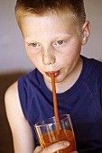 Boy drinking red vegetable juice