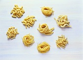 Various types of pasta on light background