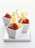 Frozen fruit on lollipop sticks