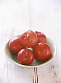Five plums in a dish