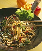 Noodles cooked in wok with asparagus and peppers