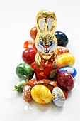 Easter Bunny surrounded by sweets and coloured eggs