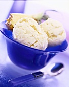 Two scoops of pineapple ice cream in dish